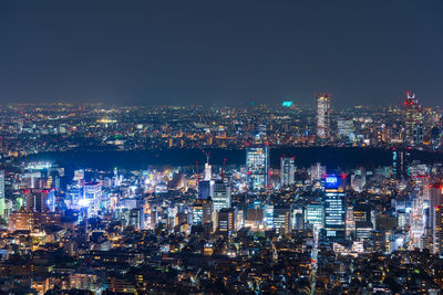 High angle view of illuminated city buildings at night