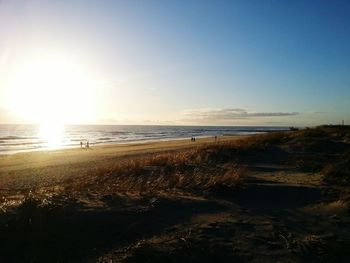 Scenic view of beach against sky during sunset