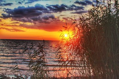 Scenic view of sea against romantic sky at sunset