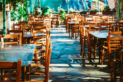 Empty chairs and tables in restaurant