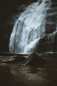 Scenic view of waterfall against sky