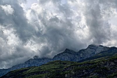 Scenic view of mountains against cloudy sky