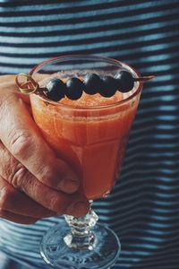 Mature man holding a glass of watermelon smoothie