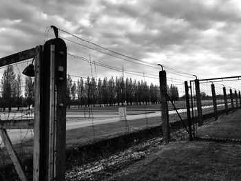 Fence on field against sky