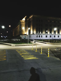 View of illuminated street and buildings at night