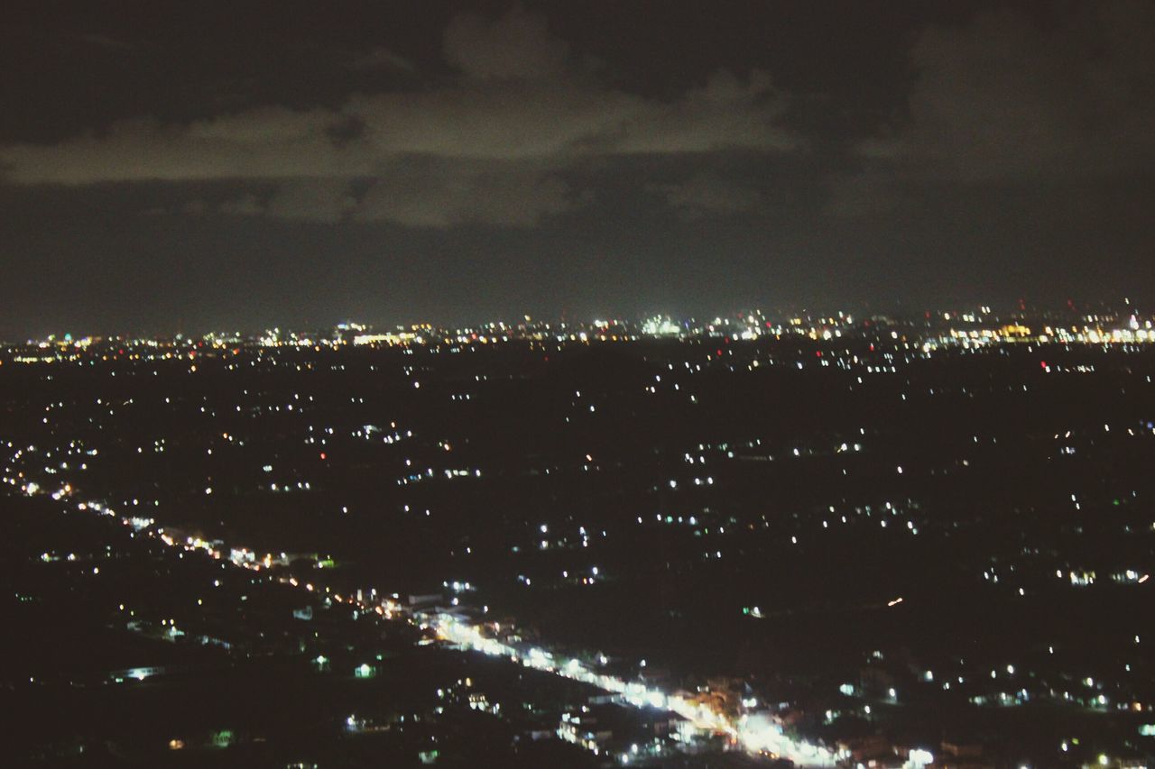 night, illuminated, cityscape, city, building exterior, sky, architecture, built structure, crowded, high angle view, residential district, aerial view, residential building, dark, light - natural phenomenon, residential structure, outdoors, cloud - sky, light, no people