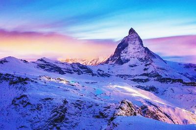 Scenic view of snow covered mountains against sky