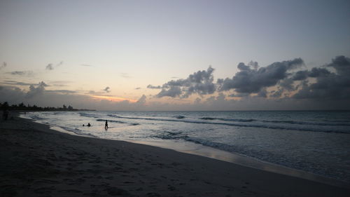Scenic view of beach against sky during sunset