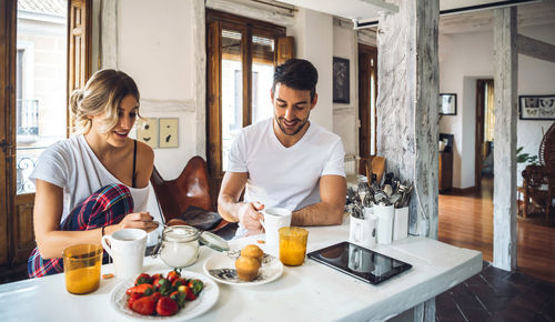 Young man and woman having food in restaurant