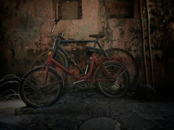 Bicycle parked on wall at night