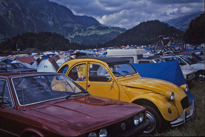 Cars on road in city against sky