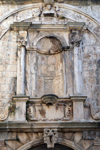 Low angle view of statue against building