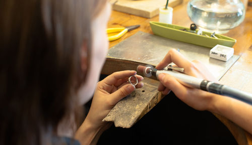 Close-up of woman working on ring