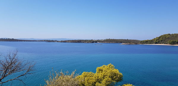 Scenic view of sea against clear blue sky