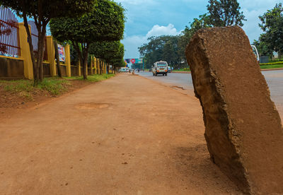 Road amidst trees against sky