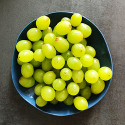High angle view of grapes in bowl on table