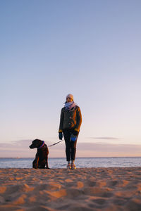 Rear view of woman walking on beach