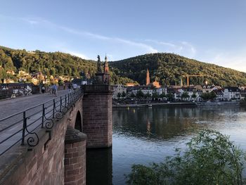 Bridge over river against buildings