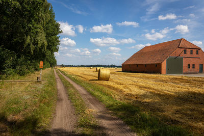 The farmer makes golden yellow straw bales from the straw on the farmland, harvesting the grain