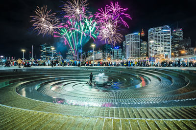 Firework display over city at night