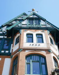 Low angle view of building against clear blue sky