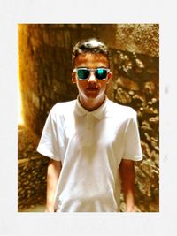 Portrait of man wearing sunglasses standing outdoors
