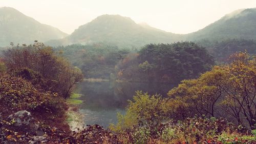 Scenic view of lake and mountains against sky