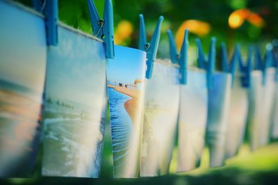 Photographs and clothespins hanging at exhibition in park