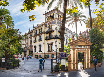 People on street amidst buildings in city