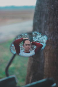 Reflection of man in side-view mirror