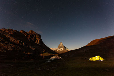 Scenic view of mountain range against star field