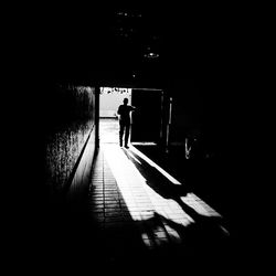 Woman walking in tunnel