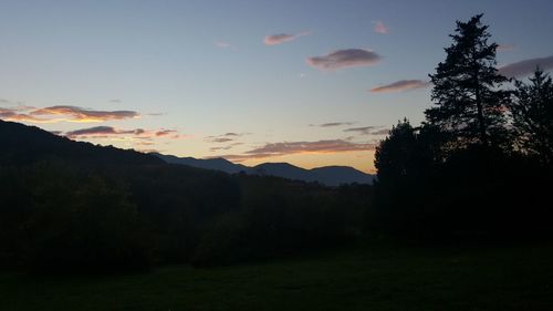 Scenic view of silhouette mountains against sky at sunset