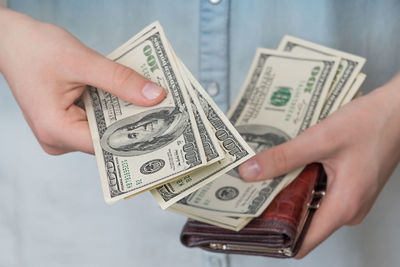 Midsection of person holding paper
