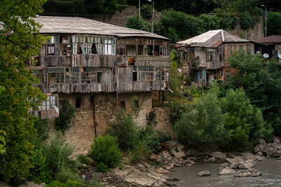 Old building by river in forest