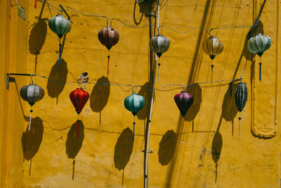 Low angle view of lanterns hanging on wall