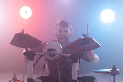 Full length of a young man holding camera