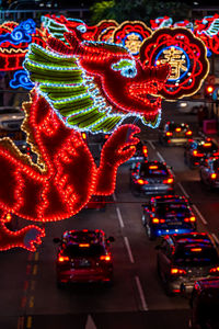 High angle view of traffic on road at night with dragon lanterns for chinese new year 