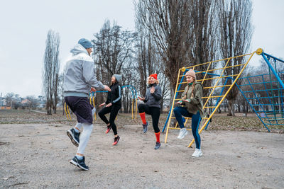 Group fitness workout classes outdoors. socially distant outdoor workout classes in public parks. 