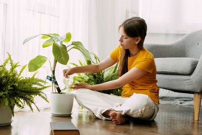 Side view of mother and daughter at home