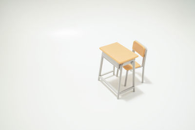 Empty chairs against white background
