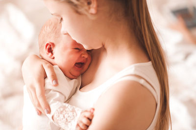 Close-up of mother holding baby girl