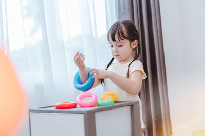 Girl playing with toy at home