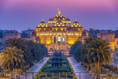 Illuminated building in city at dusk