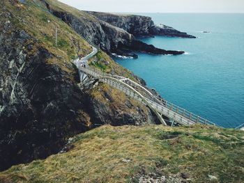 High angle view of bridge on mountains by sea