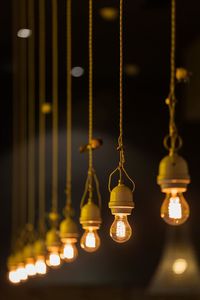 Close-up of light bulbs hanging on ceiling