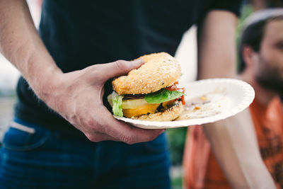 Close-up of hand holding burger