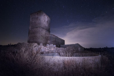 Abandoned building against sky at night