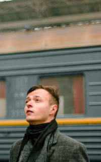 Portrait of young man looking at train