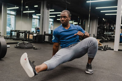 Young man exercising in gym